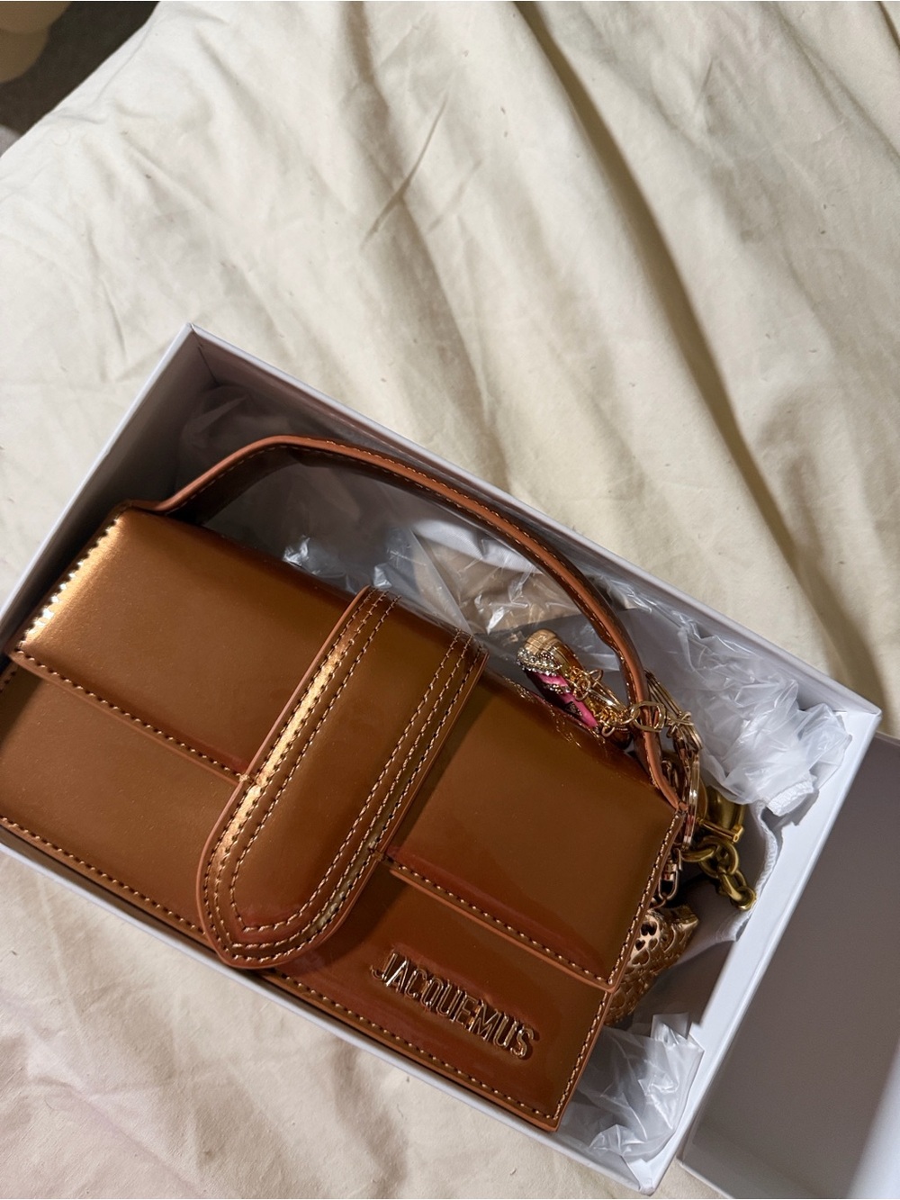 Dark Brown Patent Leather Top-Handle Bag with Gold Logo.